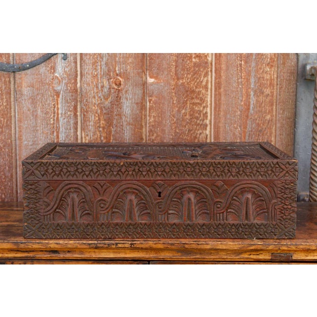 Visually stunning, this 19th century Anglo Indian carved lap desk is a work of art. It has finely carved designs all...