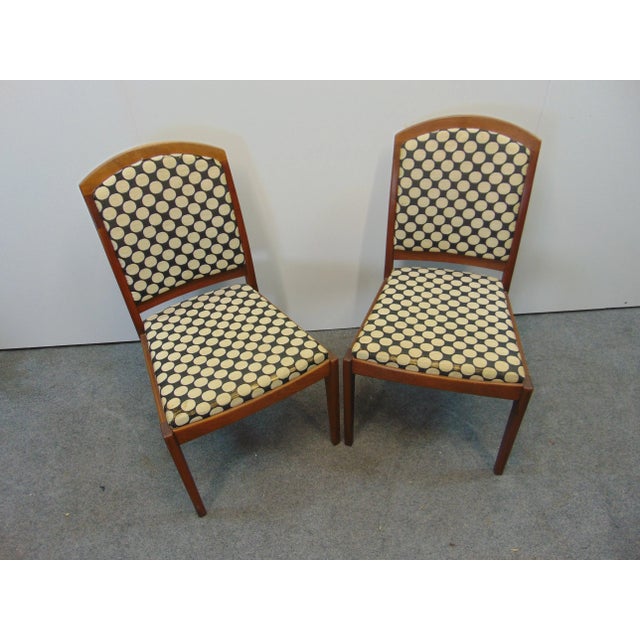 A pair of mid-century modern chairs by Brown Saltman, walnut frame with upholstered back and seats.