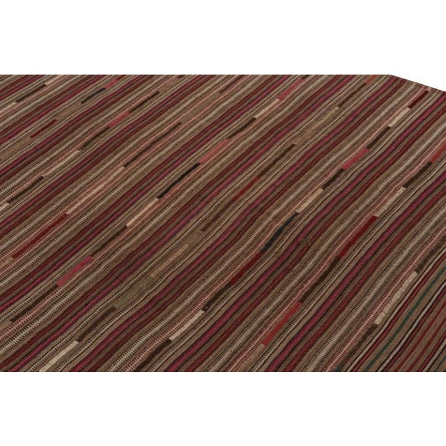 This vintage 9x10 Persian kilim is handwoven in wool, and originates circa 1950-1960. On the Design: This flatweave enjoys...