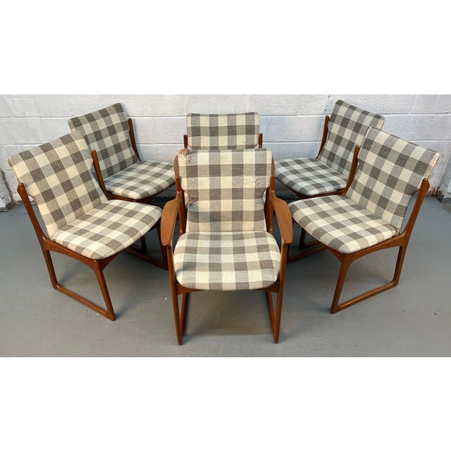 Elevate your dining space with this set of (6) Danish mid-century modern teak sled leg dining chairs by Art Furn, a...