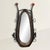 An early 20th century leather horse collar, once resting against the powerful shoulders of a draft horse, now frames a...