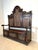 Impressive Victorian hall bench with richly carved decorative panels and integrated storage chest. This striking piece...