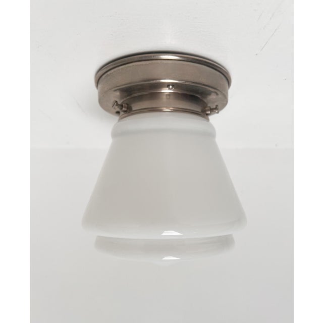 This is the ‘komeet’ ceiling lamp by w.h. Gispen for giso. An opal glass lamp on a metal base. Approximately 18 cm high...