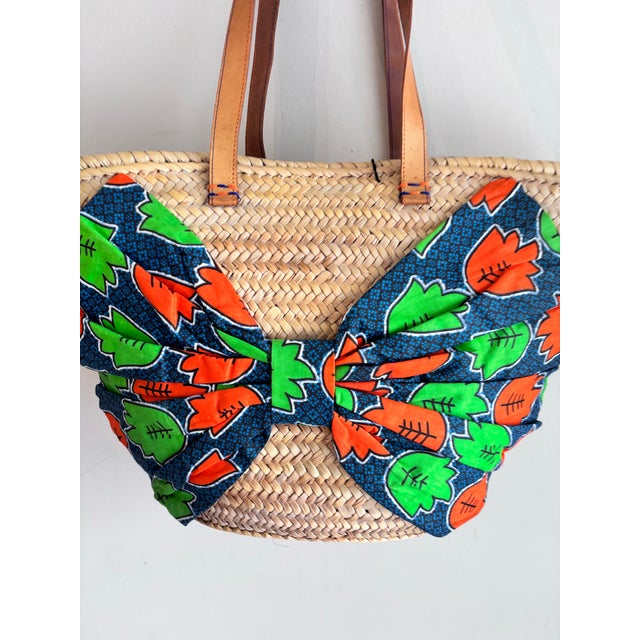 Textile A Giselle Handwoven Straw Basket / Tote Featuring a Large Bow Made From Colorful Print and Brown Leather Shoulder Straps. For Sale - Image 7 of 12