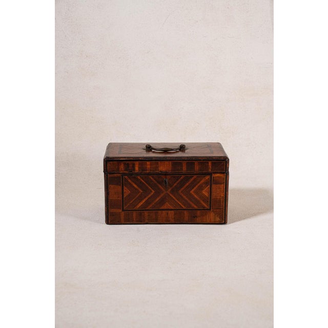 18th-century inlaid tea caddy with a brass swing handle, original hardware, working key, and geometric stringing....