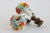 Pair of vintage Czech glass potted flower lamp finials featuring a petite bunch of colorful glass flowers surrounded by...