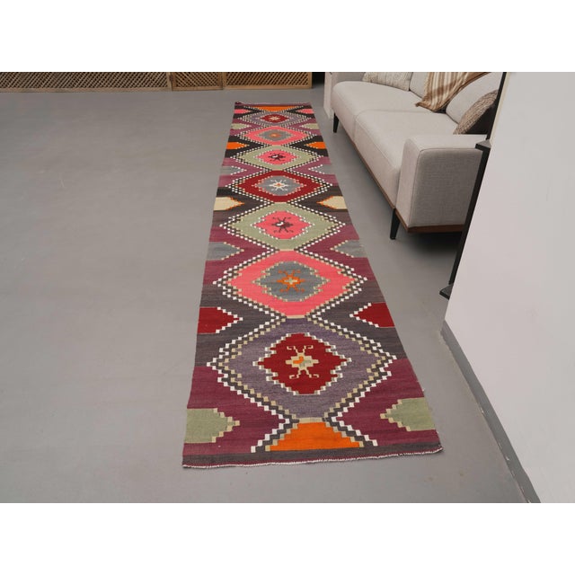 Vintage Hand-Knotted runner rug is a semi-antique vintage runner rug. The '70s Eastern region of Anatolia's unique rug is...
