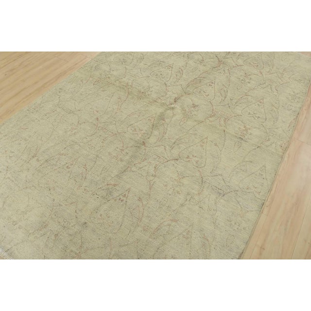 A modern Ikat rug hand-knotted with fine wool on a cotton foundation. This rug features a subtle botanical design set...