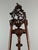 An elegant and spectacular 19th-century carved wooden painter's easel, richly decorated with plant motifs, scrolls, and...