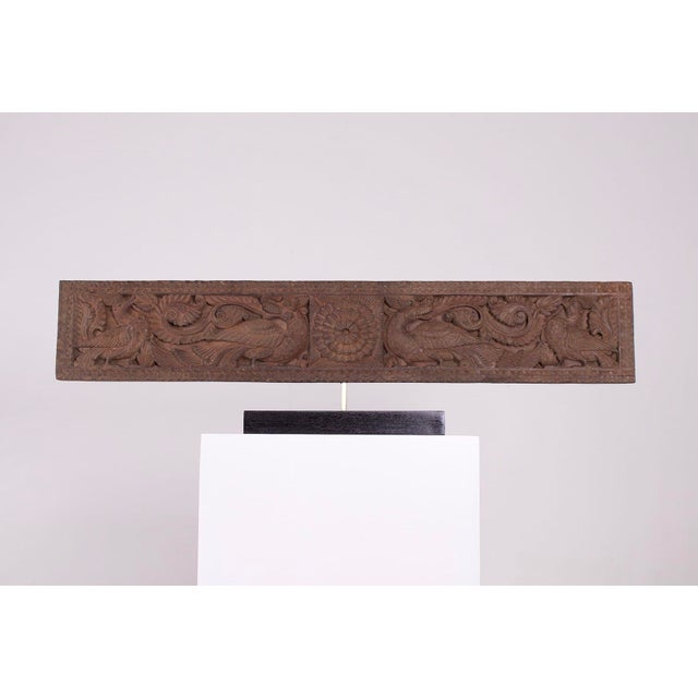A finely carved and openwork wooden architectural element from chettinad. Decorated with hamsas and fantastical creatures,...