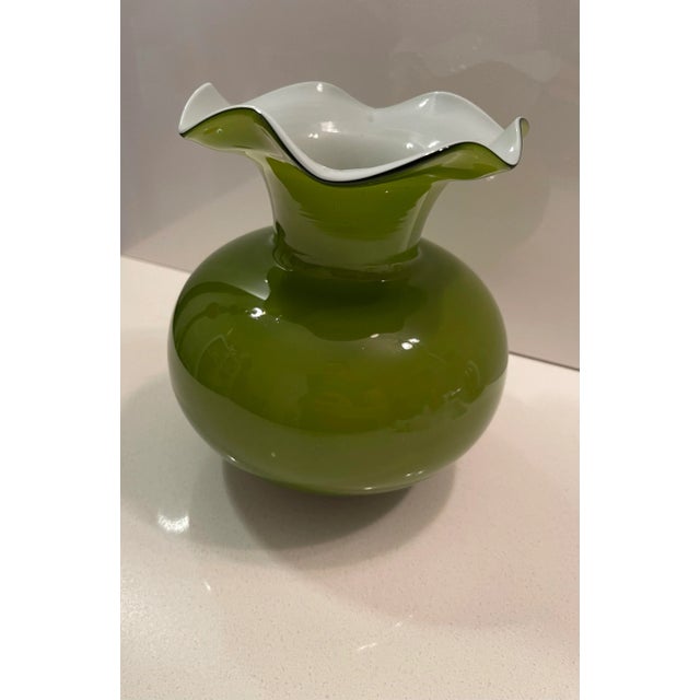 This is a lovely contemporary late vintage scalloped Olive Green Vase with a ruffled white flower top. It is absolutely...