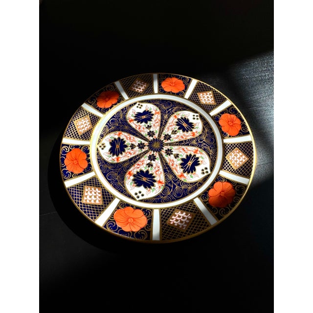 An elegant Royal Crown Derby Old Imari salad plate in the celebrated Pattern 1128, renowned for its richly detailed cobalt...