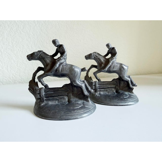 A handsome pair of vintage horse-and-rider bookends, manufactured by the Hubley Manufacturing Company in the mid-1920s....