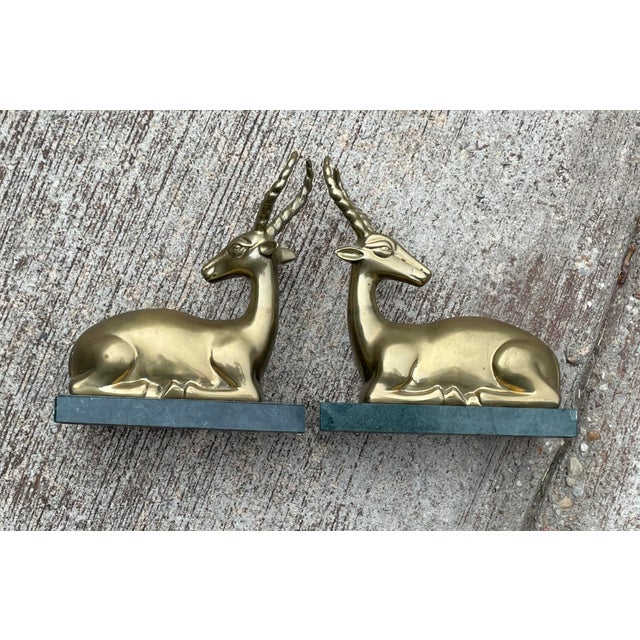 Rare laying brass ibex mounted on verde marble base.