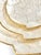 Elegant vintage capiz shell nesting trays with scalloped edges and warm brass trim, offering a soft iridescent glow....