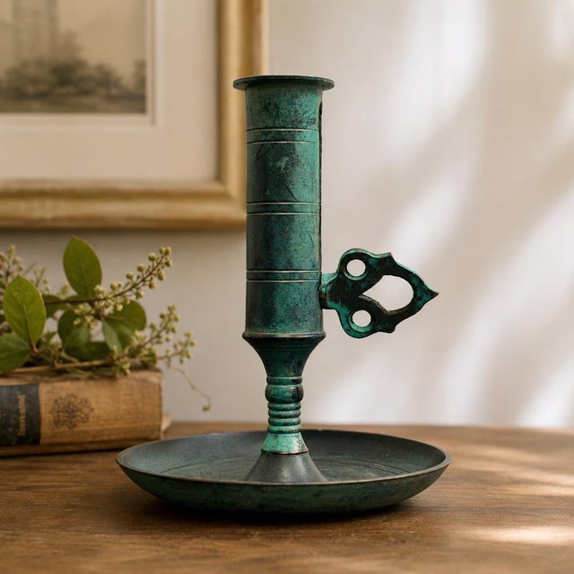 Vintage oxidized brass candlestick, featuring a candle push handle that allows you to raise the candle as it burns down —...