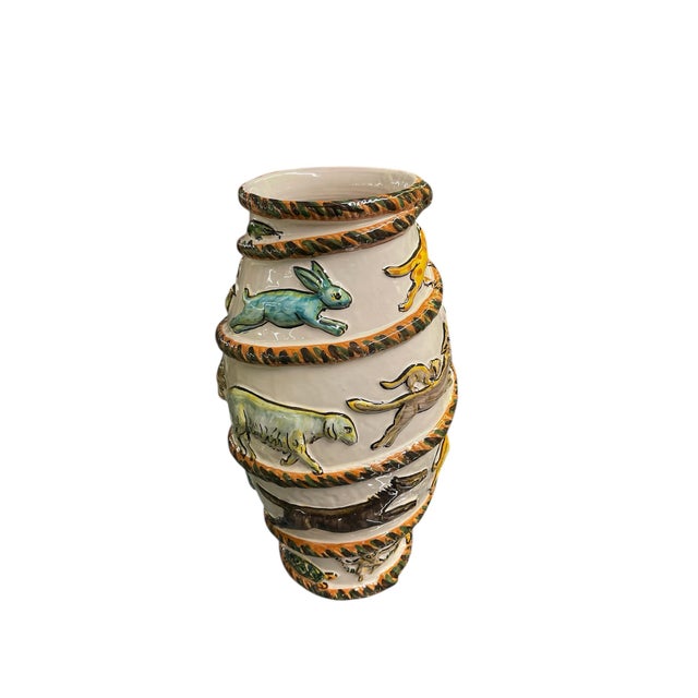 A hand-painted ceramic vase. Featuring a unique coiled rope or spiral motif, the vessel is adorned with a whimsical...