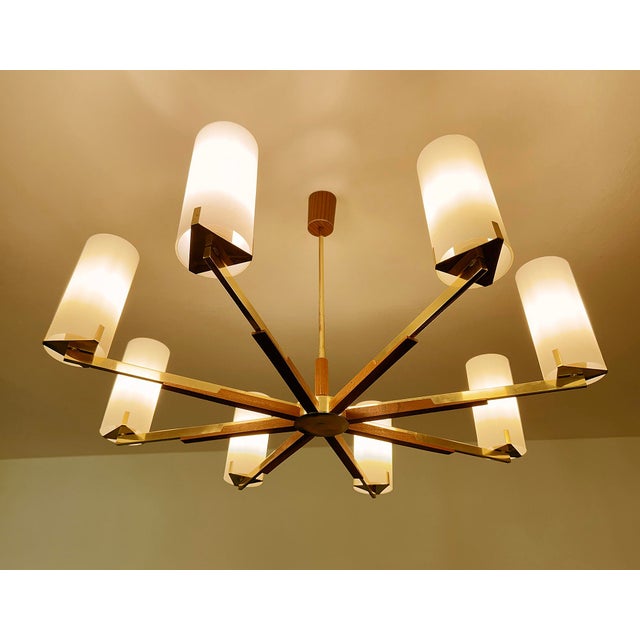 Very large scandinavian pendant light, featuring eight brass spokes with teak wood trim, arrow shaped glass support,...