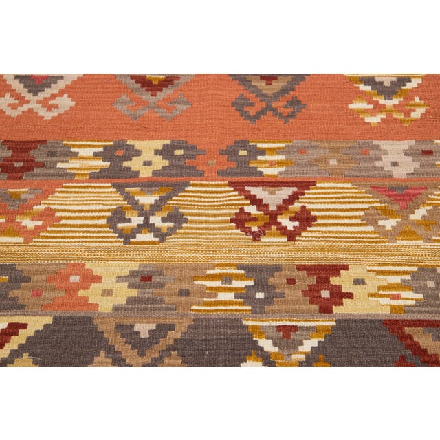 Beautiful Modern Kilim hand-knotted wool rug with multicolor accents in an all-over geometric design. This rug measures...
