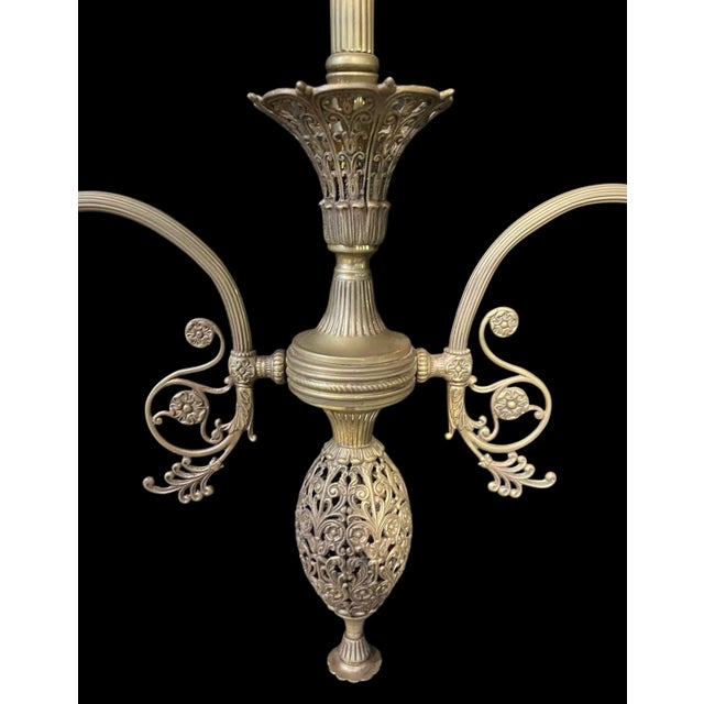 This chandelier is built for high ceilings and hangs down with an elegant grace. It is made from solid brass and houses...