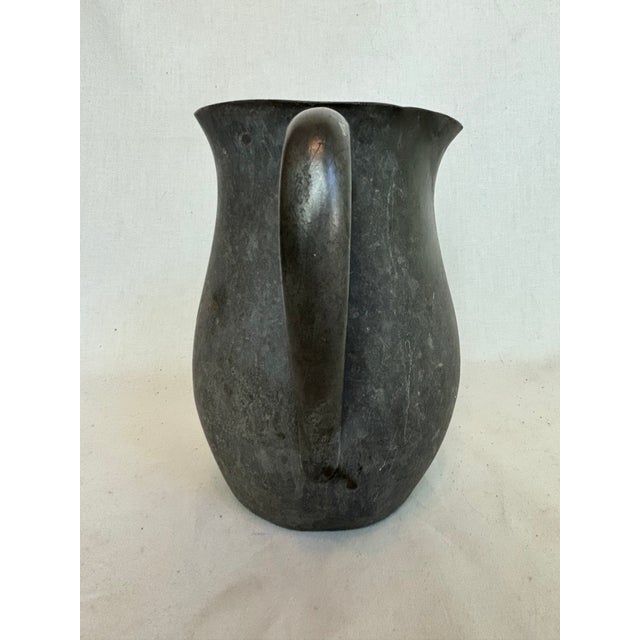 This charming antique pewter pitcher has a beautiful patina due to it's age. It will add a sense of richness and history...