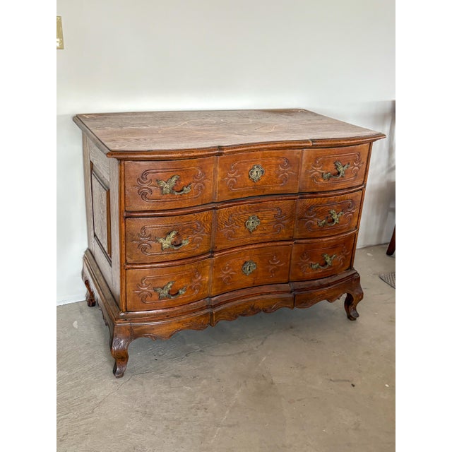 A beautifully sculptural 18th century provincial French commode, executed in richly grained oak and distinguished by its...