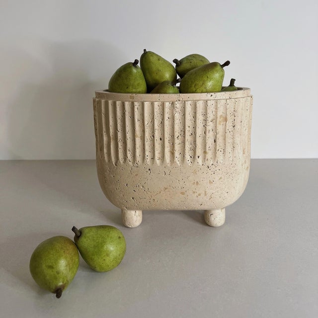 Handcrafted from white travertine, the Crenature Vase combines a softly rounded silhouette with fluted detailing and a...