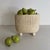 Handcrafted from white travertine, the Crenature Vase combines a softly rounded silhouette with fluted detailing and a...