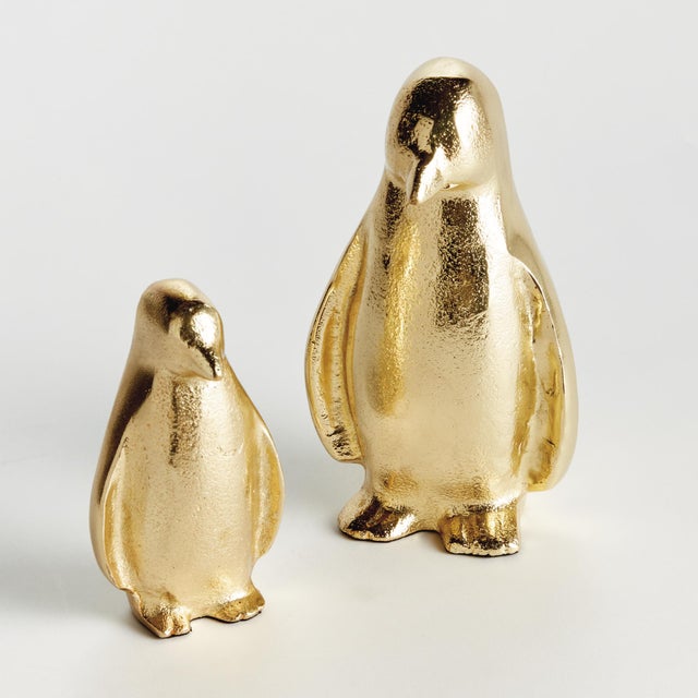 Hand crafted using a centuriesold sand cast method, this set of 2 adorable upright penguin sculptures is a charming little...