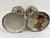 Pair of decorative metal lanterns with open lattice sides, domed tops, and distressed painted finish. Tall cylindrical...