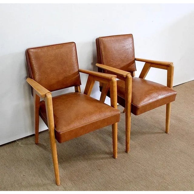 Pair of Solid Beech Bridge Chairs designed in the 1950s. Upholstered in Brown Skaï and trimmed with Ribbed Seams, these...