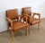 Pair of Solid Beech Bridge Chairs designed in the 1950s. Upholstered in Brown Skaï and trimmed with Ribbed Seams, these...