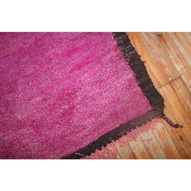 An authentic 20th-century Moroccan rug with a Minimalist pattern in fuchsia surrounded by a narrow brown border. Boho chic...