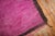 An authentic 20th-century Moroccan rug with a Minimalist pattern in fuchsia surrounded by a narrow brown border. Boho chic...
