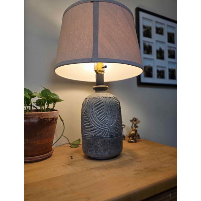 Gorgeous vintage 1980s statement table lamp featuring a heavily textured, distressed gray ceramic finish with deep,...