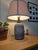 Gorgeous vintage 1980s statement table lamp featuring a heavily textured, distressed gray ceramic finish with deep,...