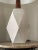 Rare diamond shaped table lamp in off white/ light grey with incised detail by ceramicist duo Jane and Gordon Martz. This...