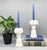 Exquisite pair of white glazed porcelain candlestick holders featuring intricately applied floral bouquet tops. Each is...