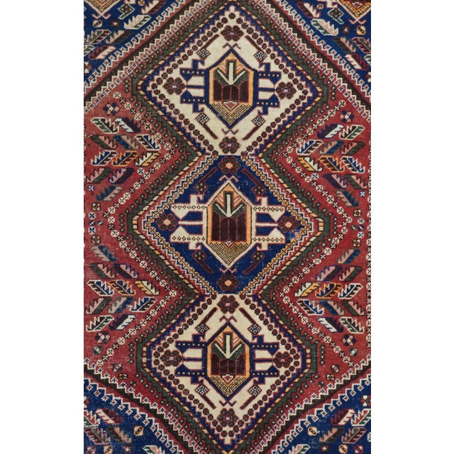 A pole medallion of three bnest4ed, stepped, conjoint octagons in old ivory and royal blue, with angular "Qashghai gul"...