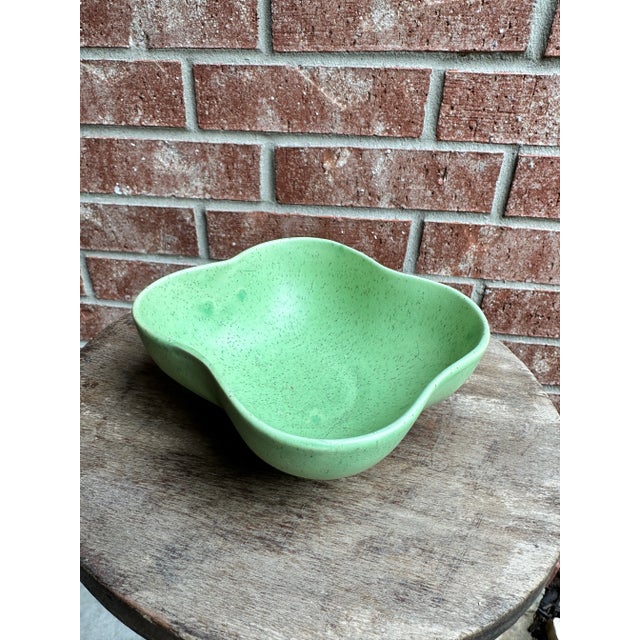 Vintage signed American pottery catchall bowl. Speckled green glaze over ceramic.