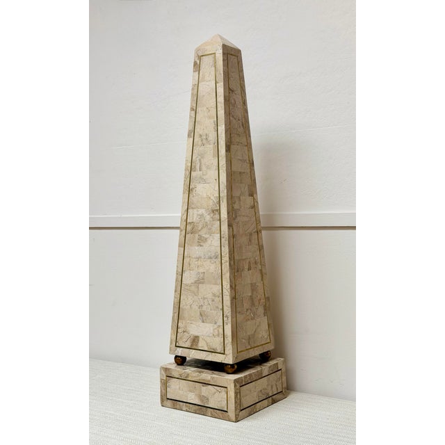 We are very pleased to offer this elegant Maitland Smith tessellated stone obelisk sculpture, circa 1980s, masterfully...
