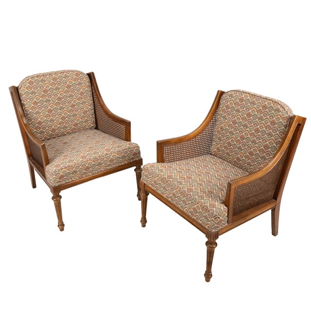 This stunning pair of 1960s French-style bergère chairs brings a perfect blend of Hollywood Regency glamour and classic...