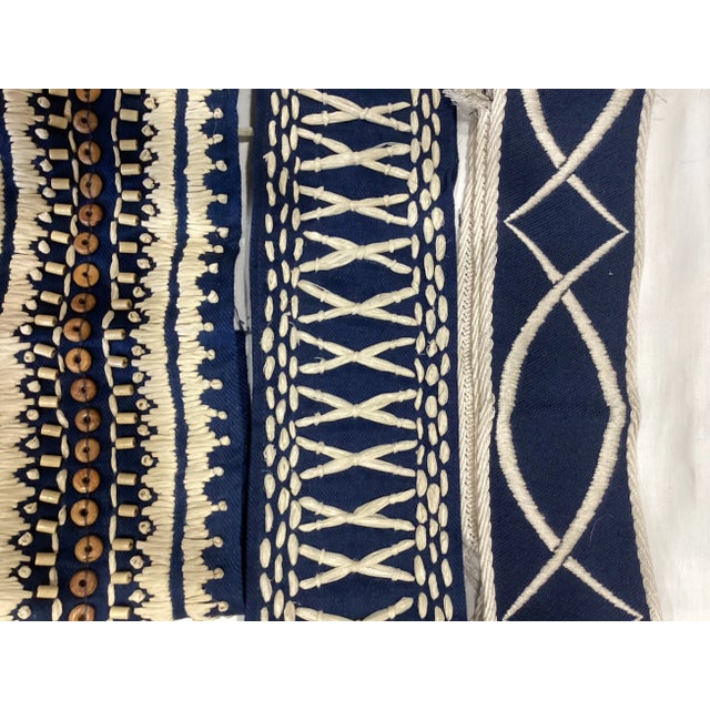 Navy blue pieces one with white stitching measuring 35 inches, another with raffia stitching measuring 26 inches and a...