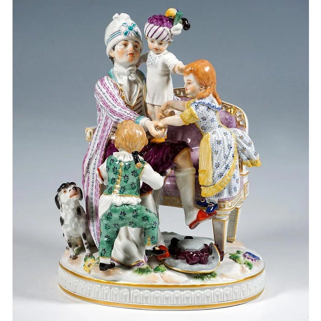 Excellent meissen porcelain genre group: the father in domestic garb (housecoat over elaborate house clothes, slippers,...