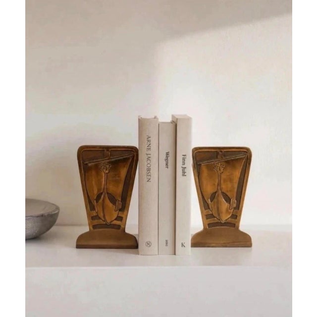 Sculptural pair of vintage bookends featuring stylised Viking ship motifs in relief. Each bookend has a strong geometric...