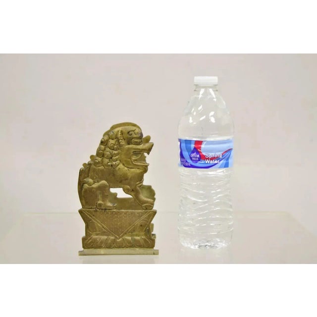 Vintage Chinese Foo Dog Solid Brass Figural Bookend. Circa Mid 20th Century. Measurements: 6" H x 3.5" W x 3" D.