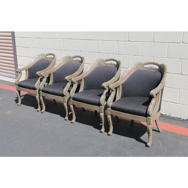 A striking set of four Italian-style armchairs from the 1990s, featuring beautifully carved wood frames with elegant...