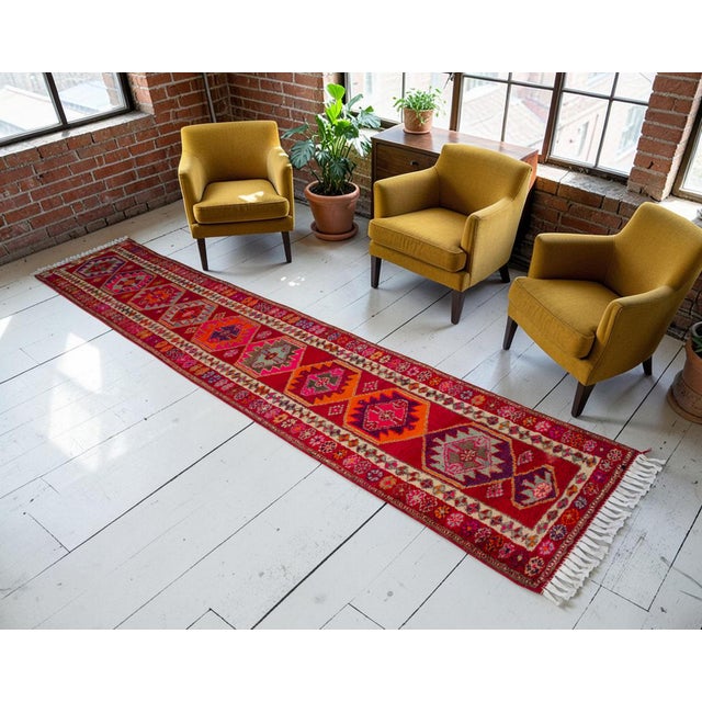 Woven in the 1970s in Southeastern Anatolia, Turkey, this hand-knotted long runner rug showcases a spectacular, vibrant...