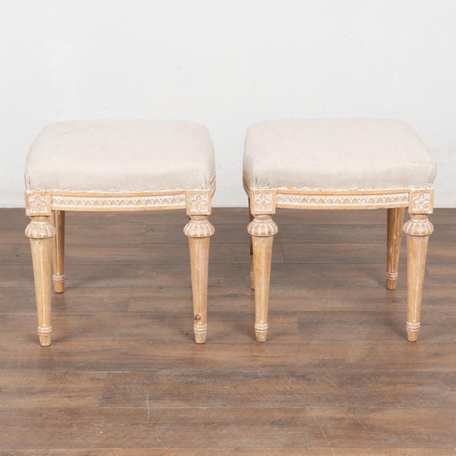 Pair of early 20th century Swedish taboret stools crafted in pine. Each stool features turned, tapered legs and carved egg...