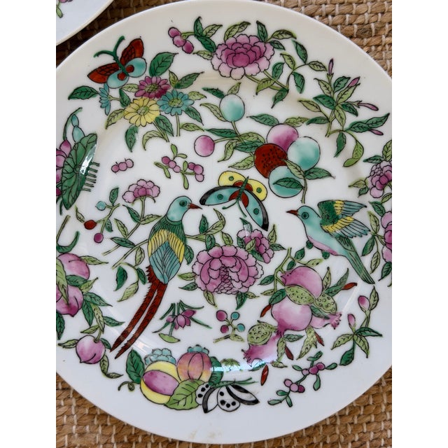 Charming set of vintage porcelain plates featuring an exuberant Chinese-inspired famille rose / Chinoiserie design. Each...